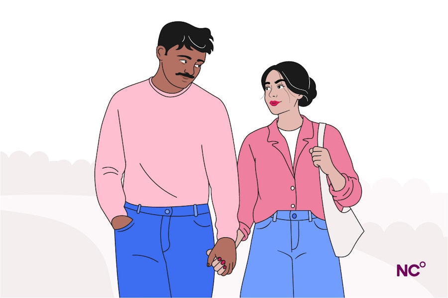 Couple holding hands, while looking at each other