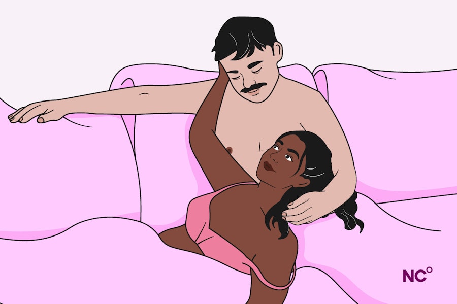 Couple cuddling in bed