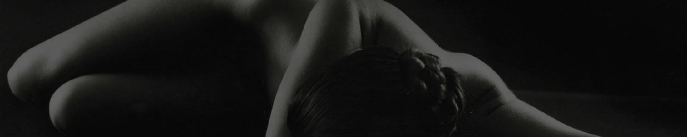 woman laying down in a dark background