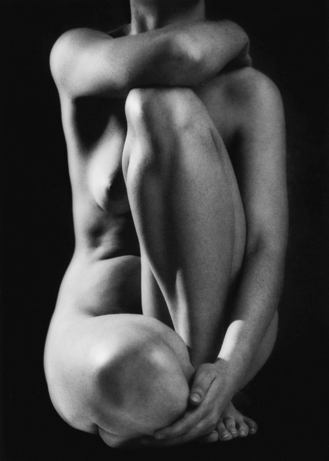 nude woman sitting down