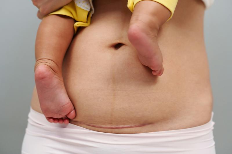 stomach of a woman and the feet of her baby