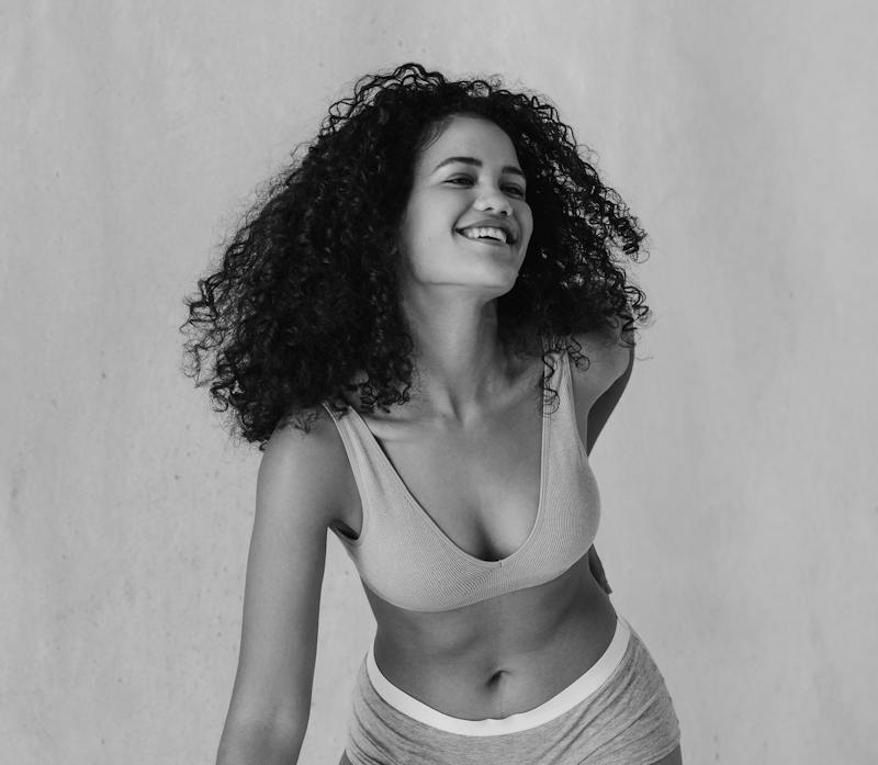woman in underwear leaning forward