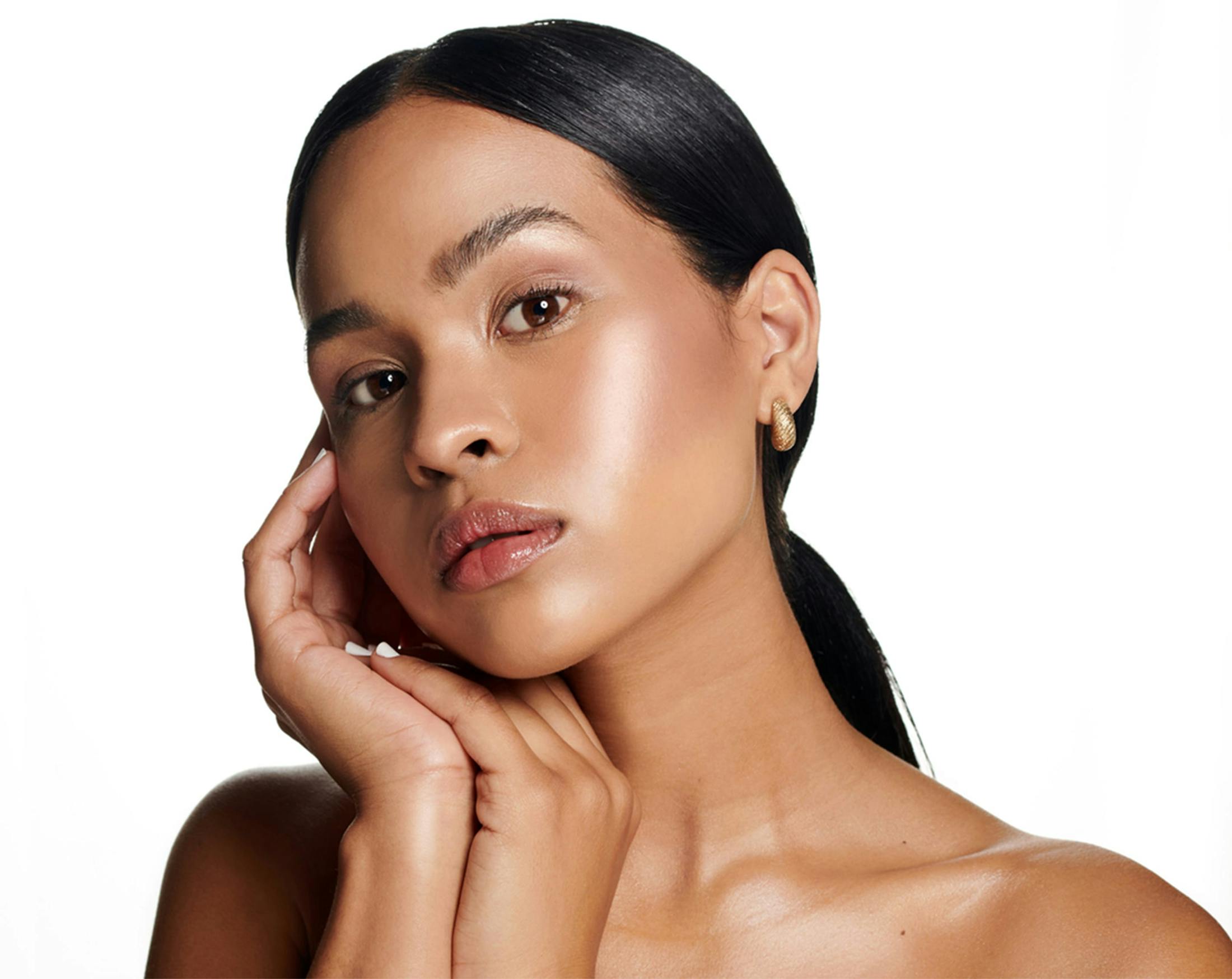 woman touching her cheek and chin