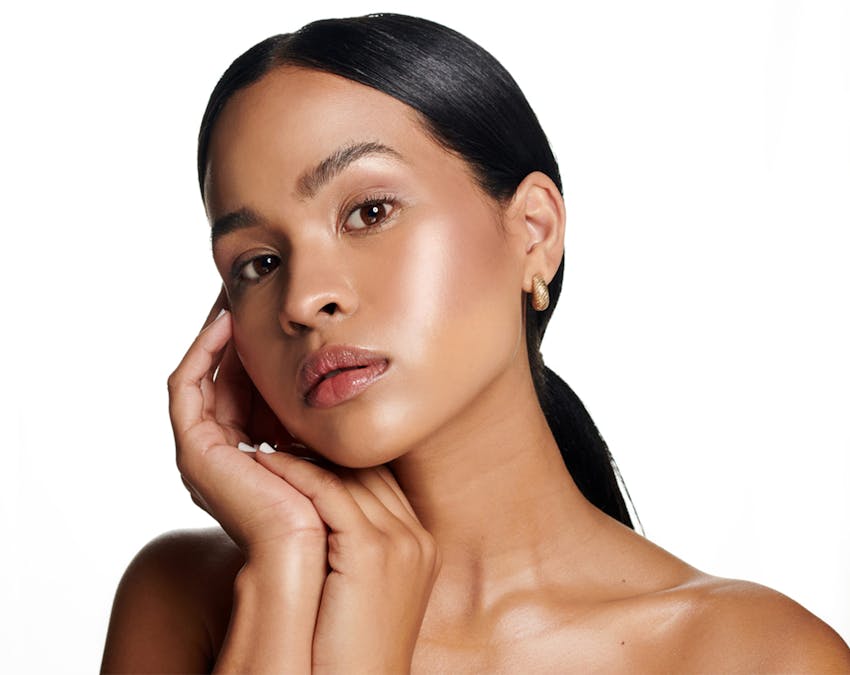 woman touching her cheek and chin