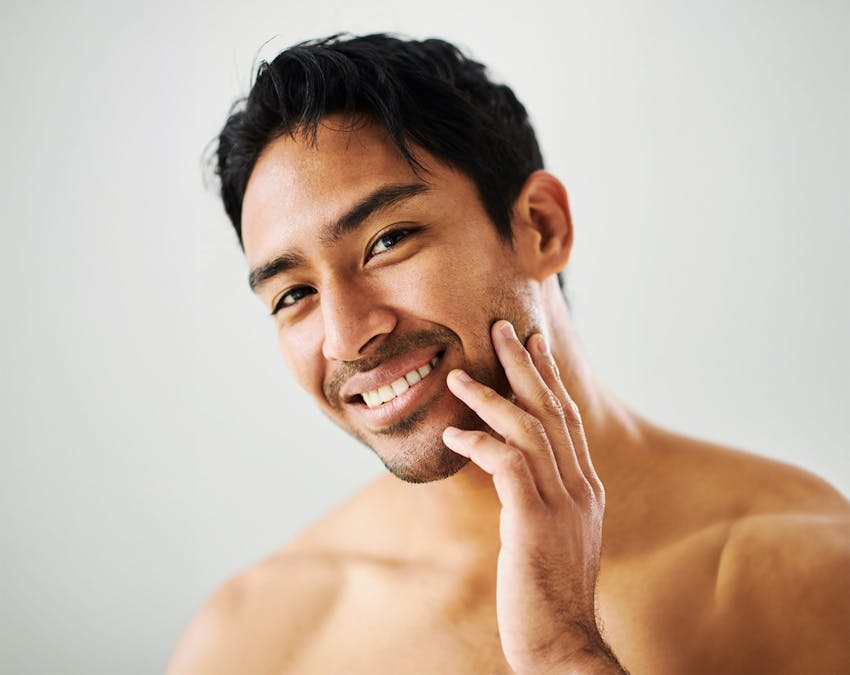 man touching his jaw