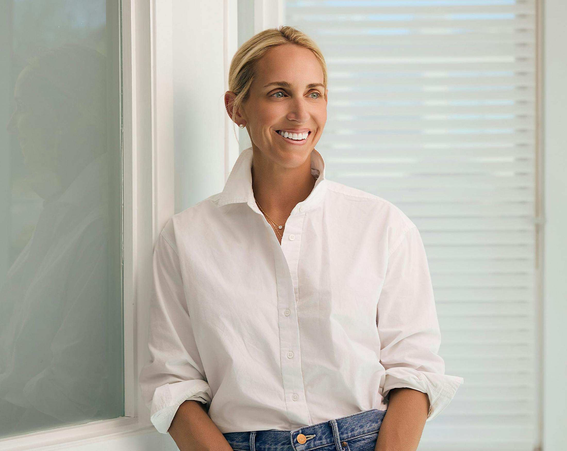woman in a white button up top