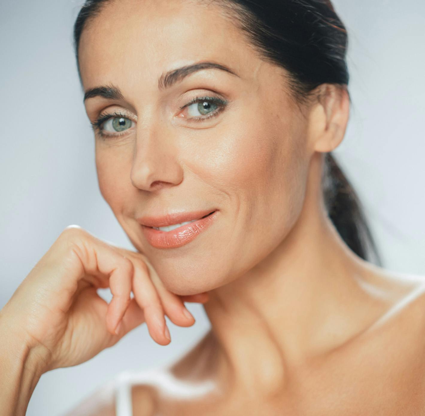 woman touching her chin