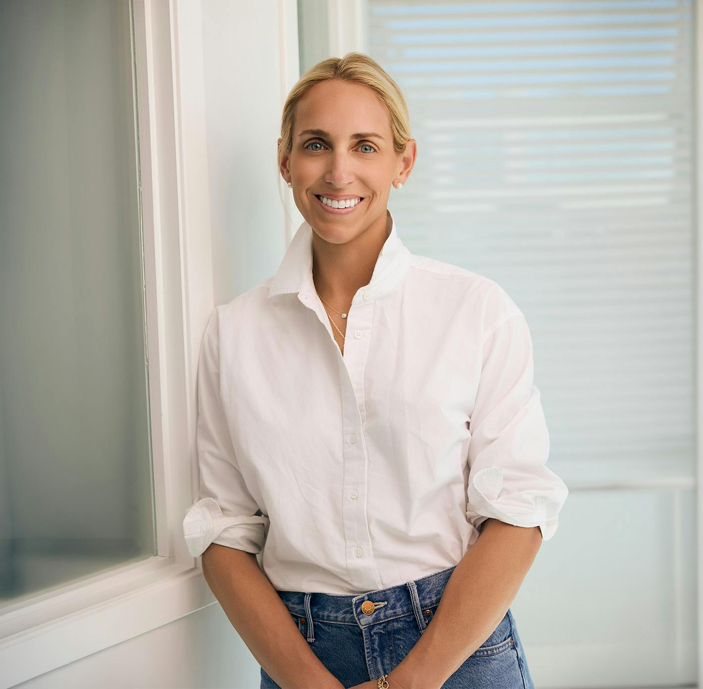 woman in a white button up top