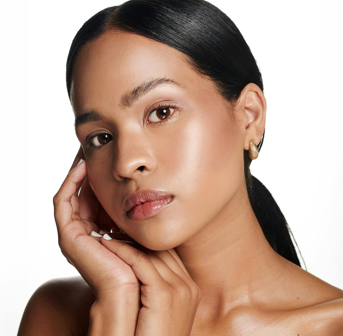 woman touching the side of her face