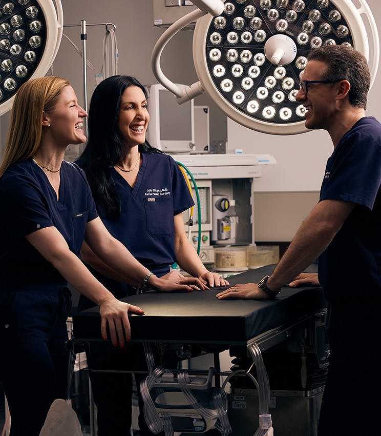 Dr. Bloom laughing with his staff