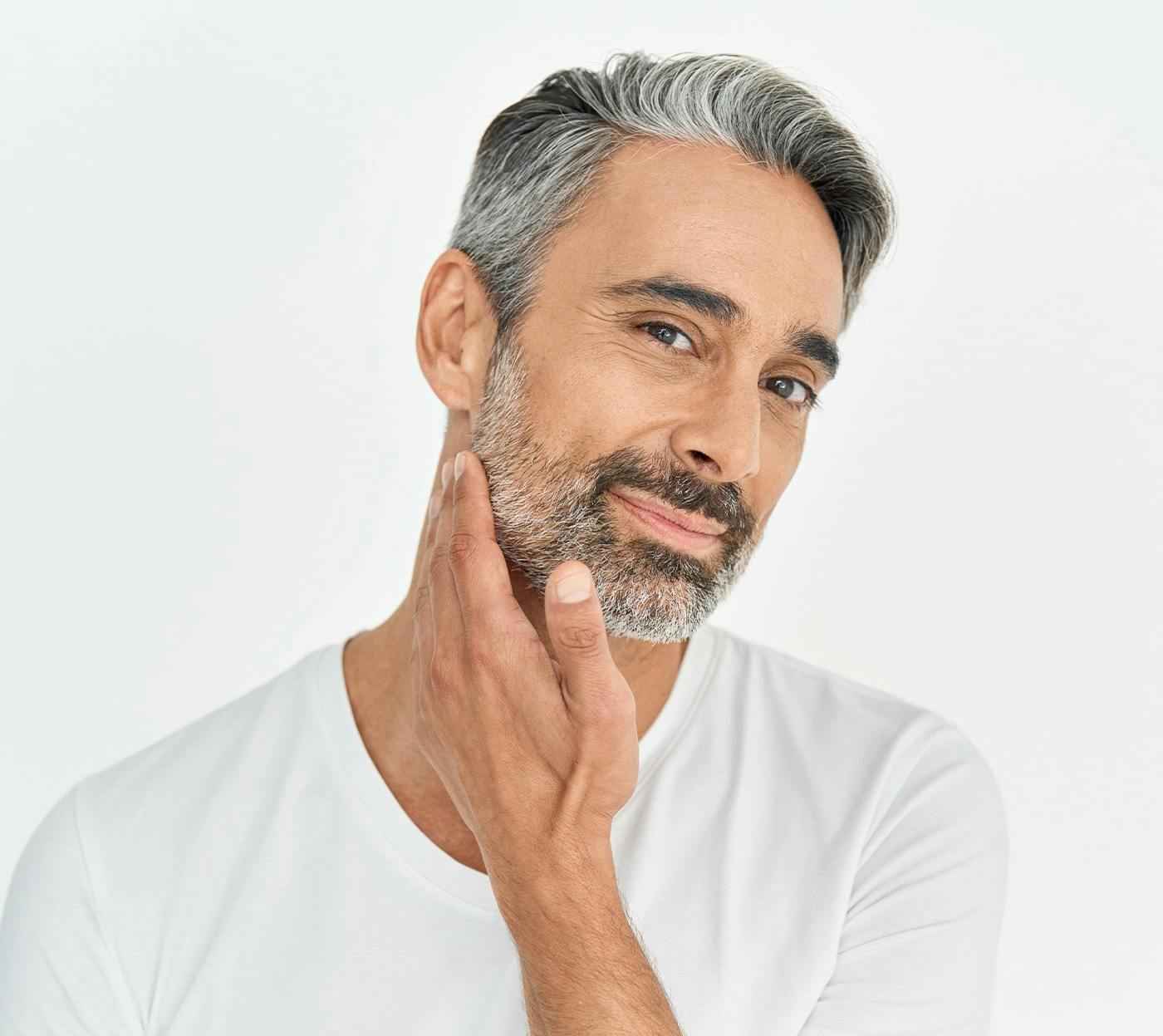 older man touching his jaw