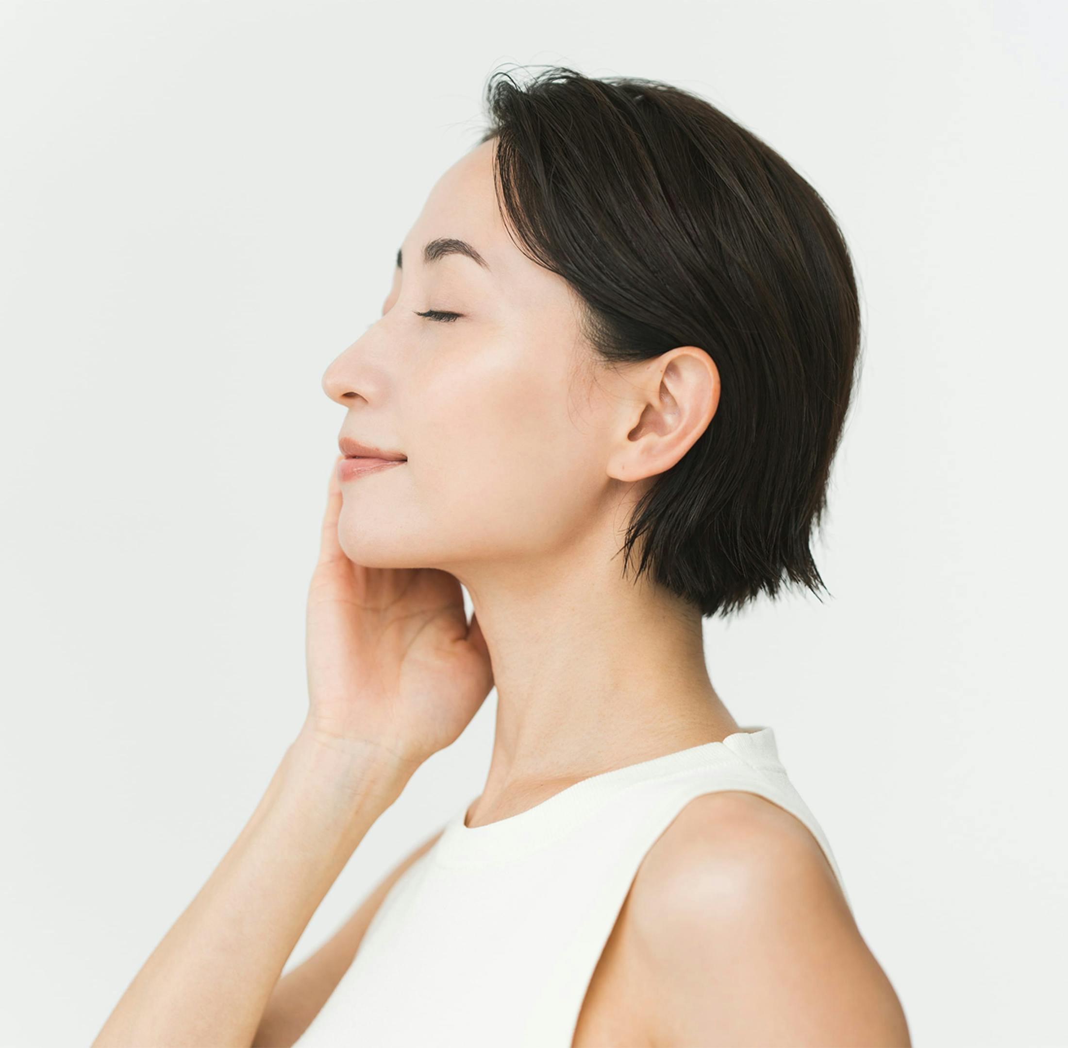 woman touching her neck