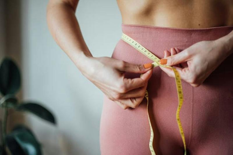 Woman Measuring Her Stomach