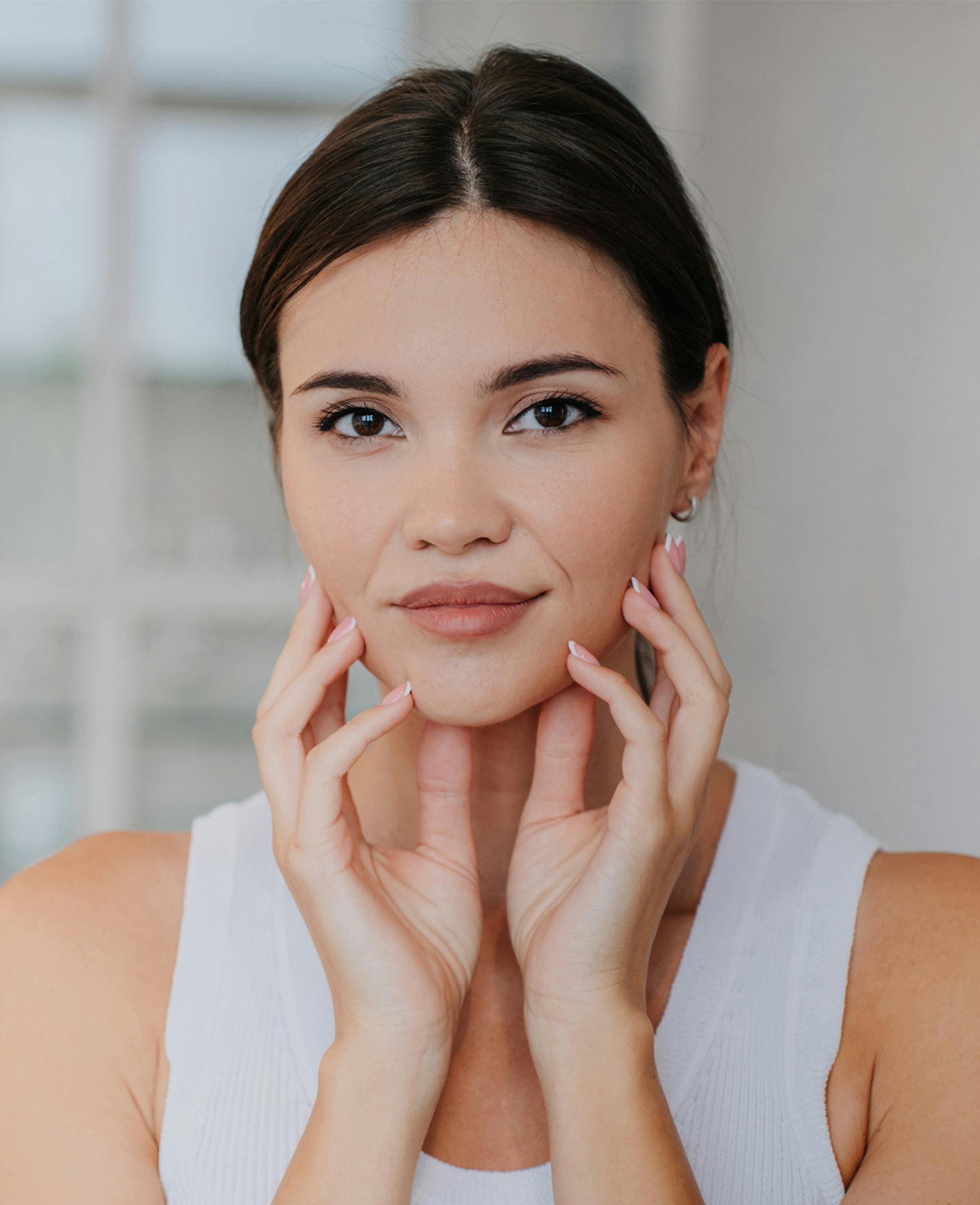 model holding her face