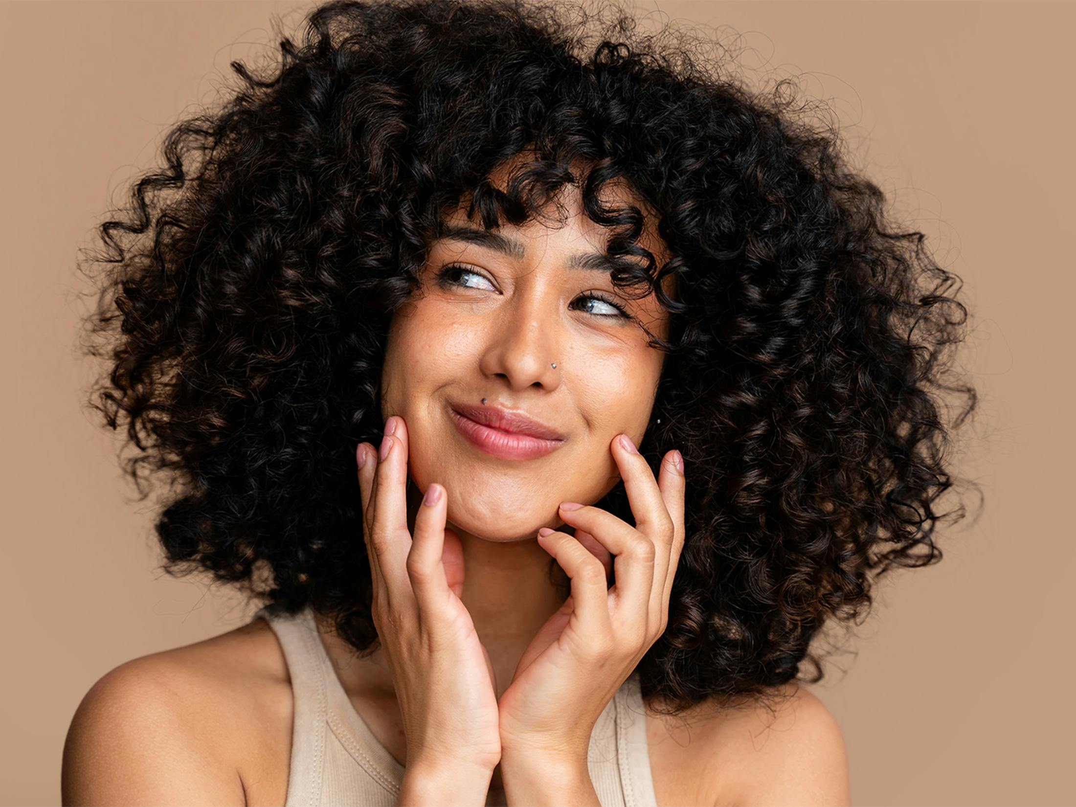 women posing holding her face in her hands