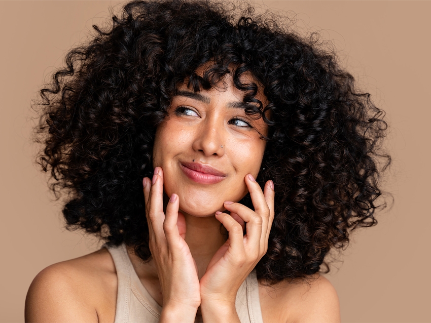 women posing holding her face in her hands