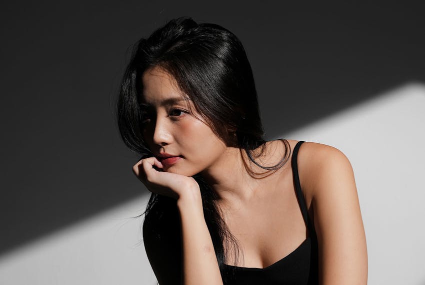 Woman resting chin on hand
