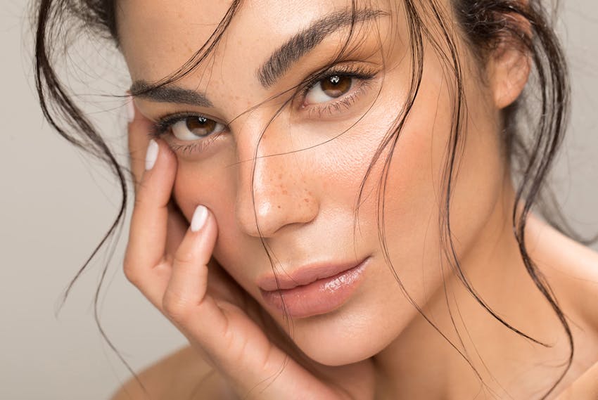 Woman touching her face
