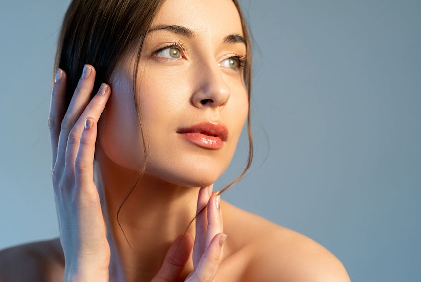 Woman touching her cheek and chin
