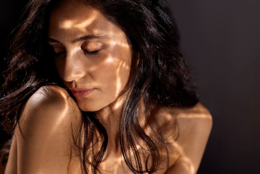 Woman with water reflections on her face