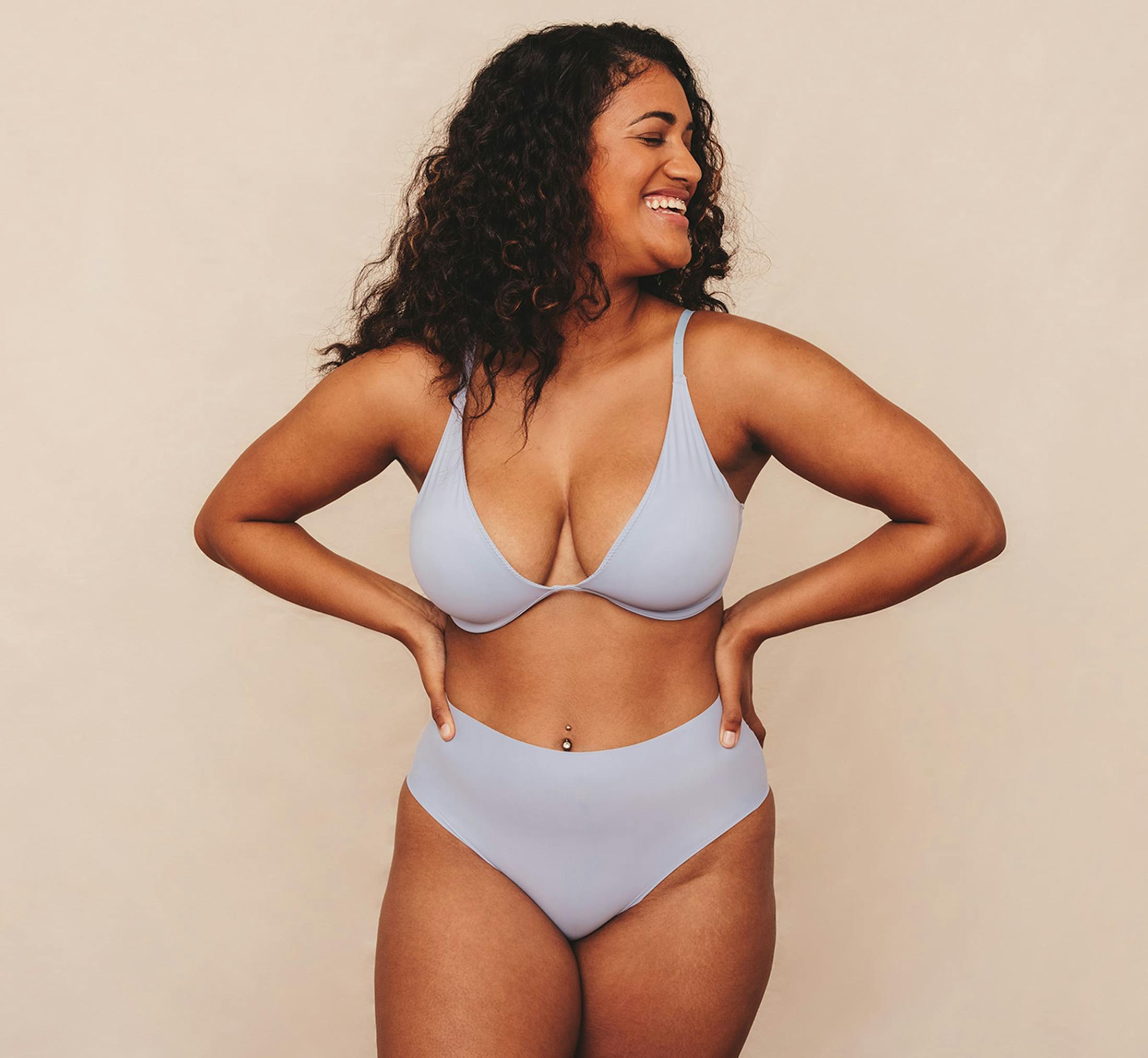 woman smiling with hands on hips