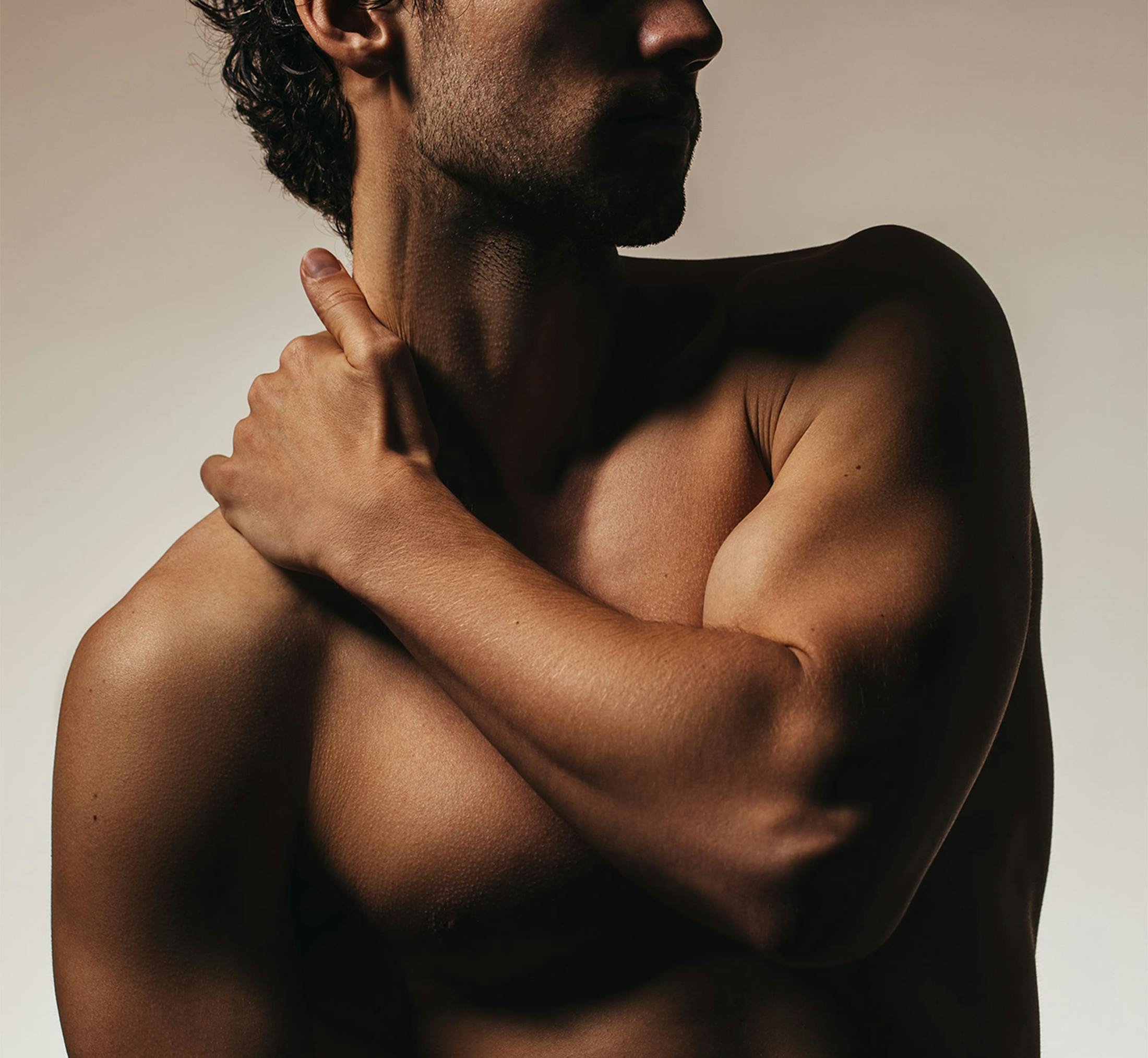 Man touching his neck