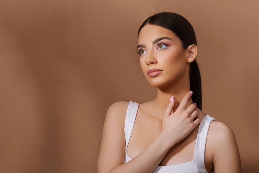 Woman touching her neck