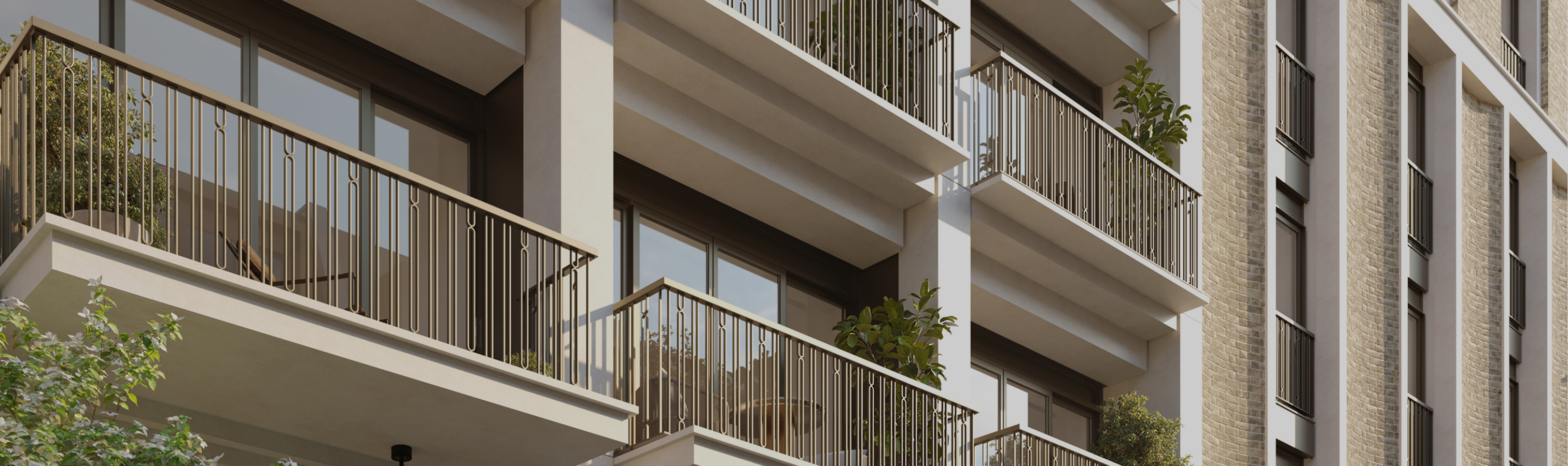 Stacked balconies with slim metal railings on a pale stone and brick apartment building