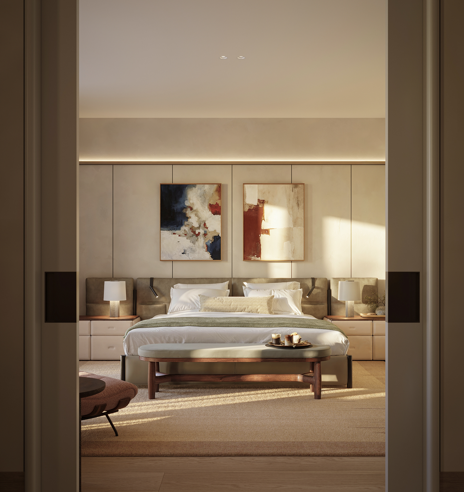 Bedroom seen through open doors, with an upholstered bed, bench, bedside lamps and two abstract paintings