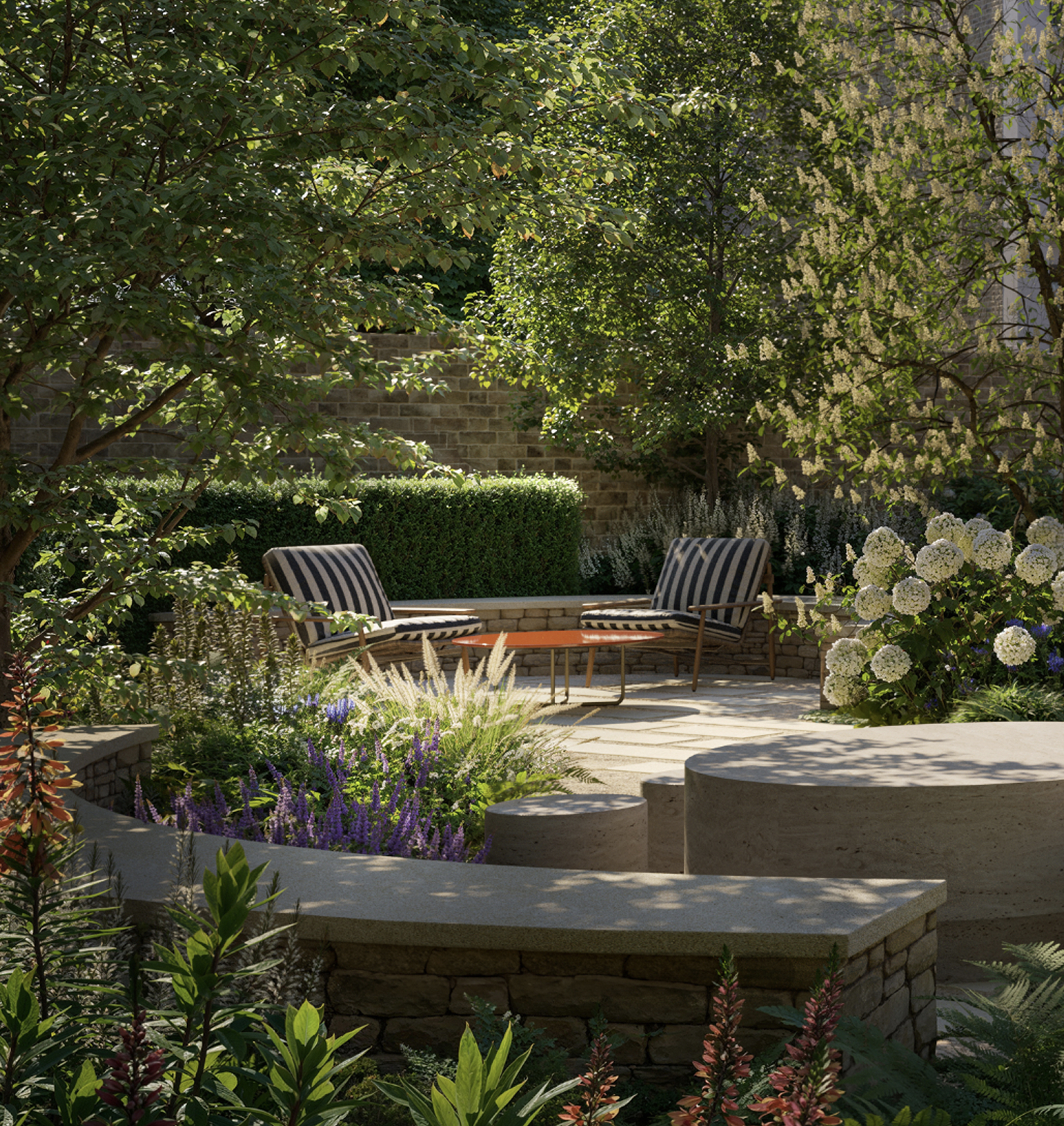 Secluded garden seating area with striped lounge chairs, stone walls, hydrangeas and lush planting