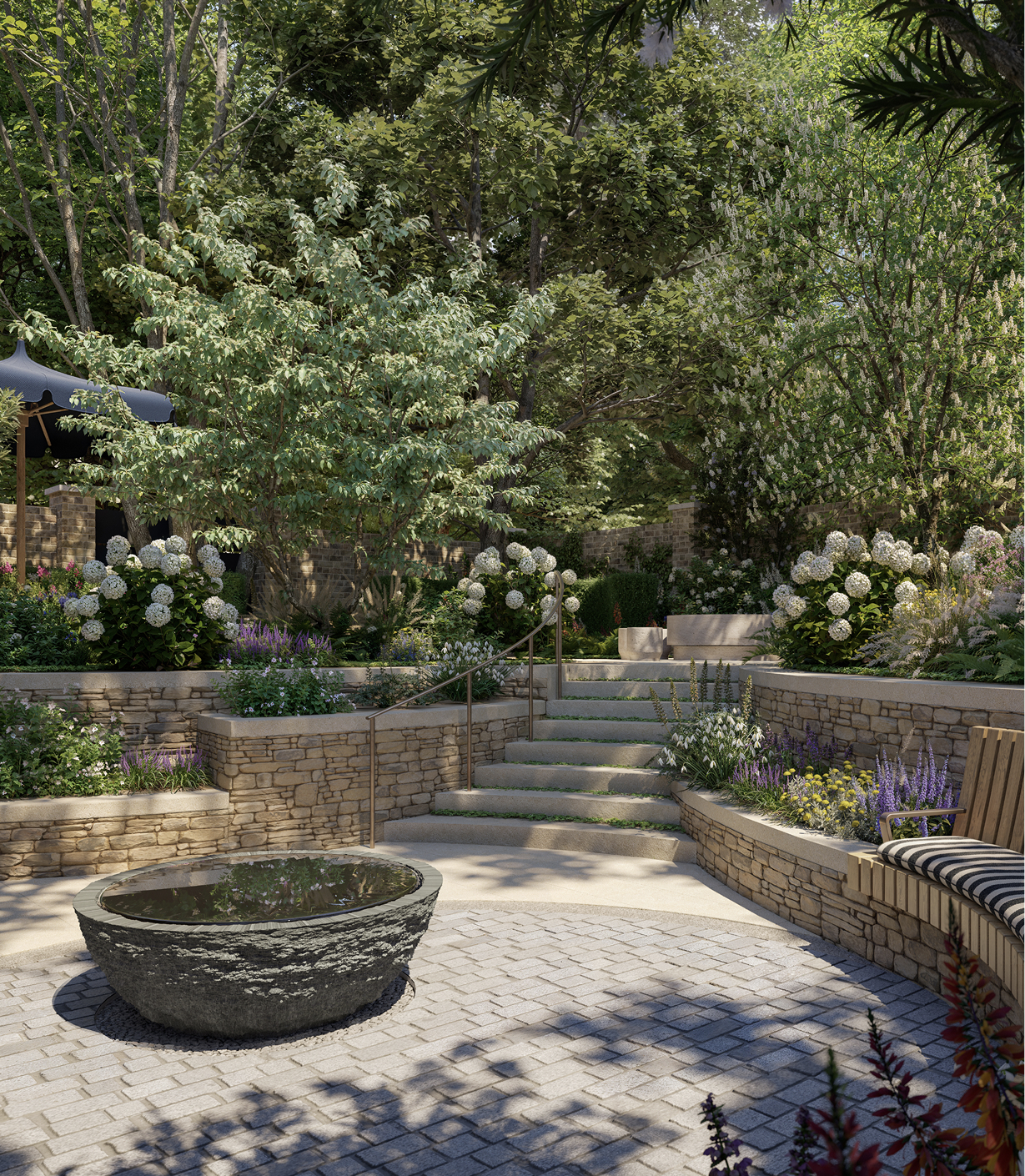 Sunken paved circle with a stone water bowl, stone steps and hydrangeas in the Sanctuary Garden