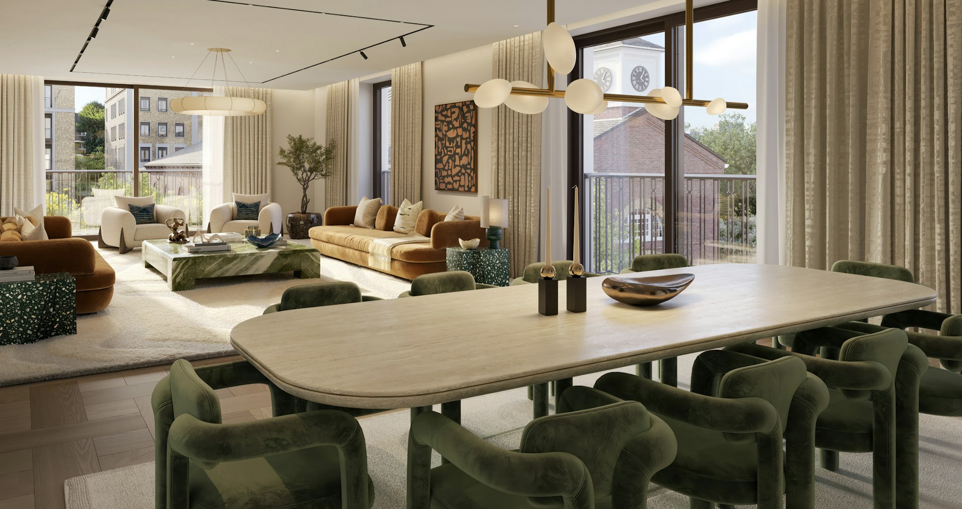 Open-plan living and dining room with green velvet chairs, an oval stone table and views of trees and rooftops