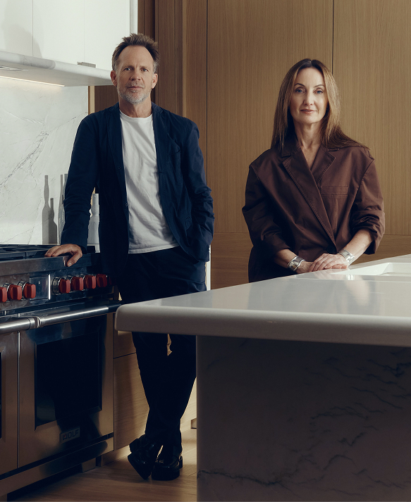 Jonathan Richards and Kirsten Stanisich, the interior designers of the luxury townhouses for sale in St John's Wood Square, standing in a marble kitchen.