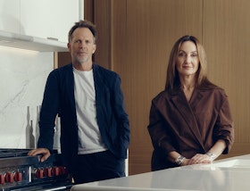 Jonathan Richards and Kirsten Stanisich, the interior designers of the luxury townhouses for sale in St John's Wood Square, standing in a marble kitchen.