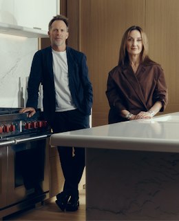 Jonathan Richards and Kirsten Stanisich, the interior designers of the luxury townhouses for sale in St John's Wood Square, standing in a marble kitchen.