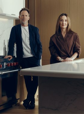 Jonathan Richards and Kirsten Stanisich, the interior designers of the luxury townhouses for sale in St John's Wood Square, standing in a marble kitchen.