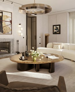 Living room by Yabu Pushelberg with a fireplace, curved cream sofa and bronze-edged coffee table