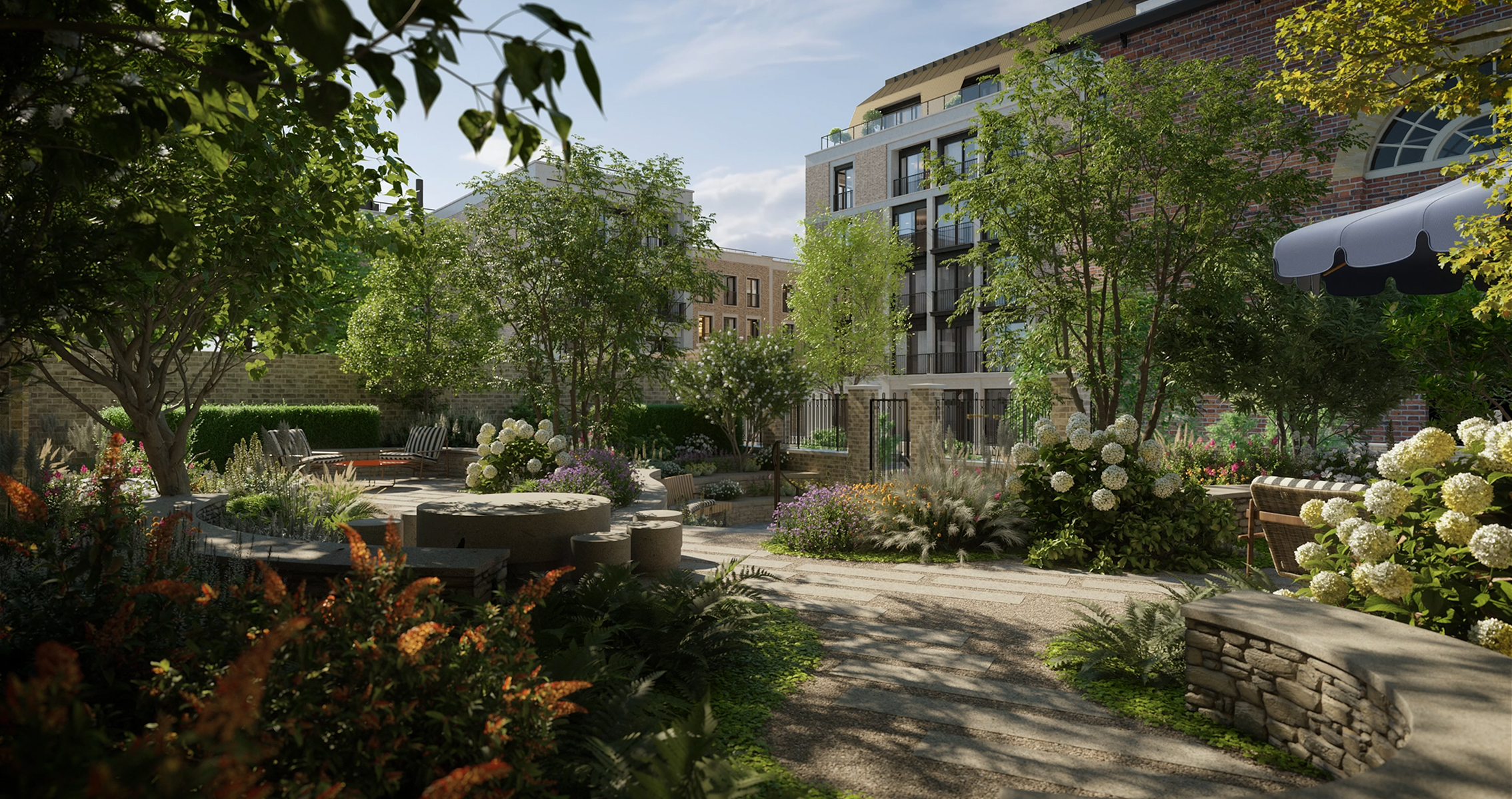 Landscaped communal garden with winding paths, hydrangeas and dry-stone walls between the residences
