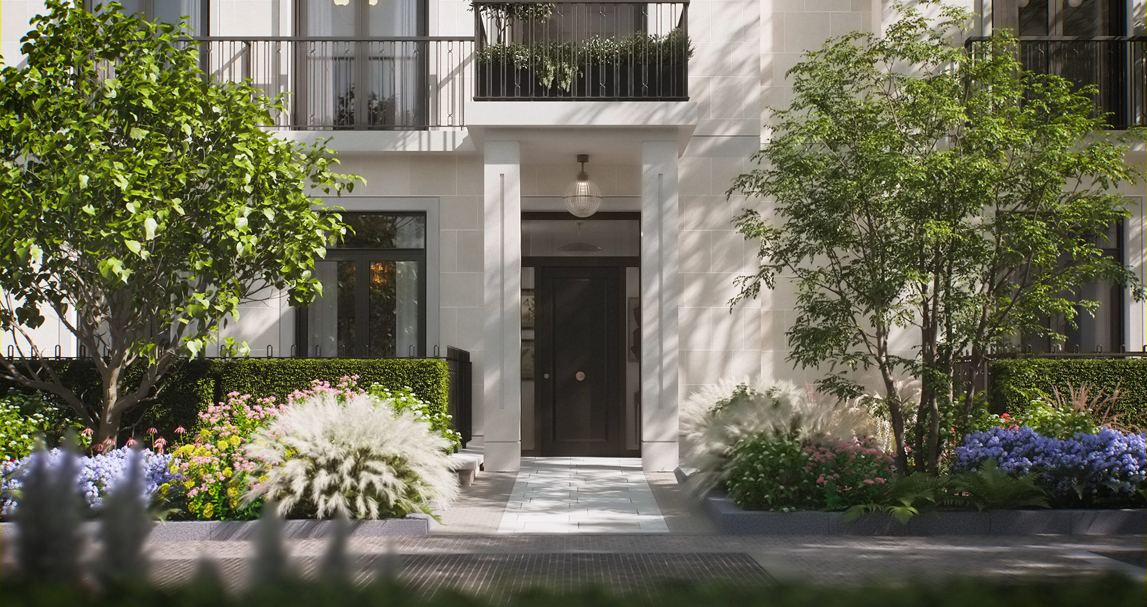 Pale stone entrance with a dark front door, framed by trees, hydrangeas and ornamental grasses at St John's Wood Square