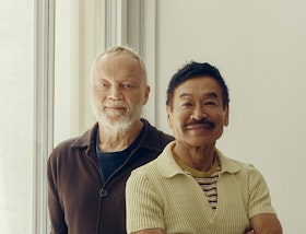 The two founders of Yabu Pushelberg by a sunlit window, one seated with his arms folded