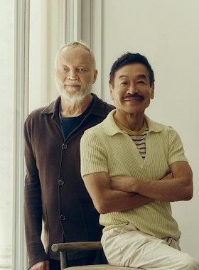 The two founders of Yabu Pushelberg by a sunlit window, one seated with his arms folded