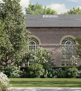 The 1825 Riding School, reimagined as The Riding Club, seen across The Lawn at St John's Wood Square in London