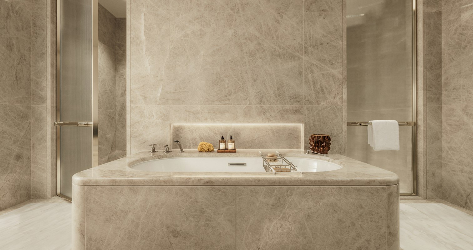 Bathroom set with Loewe toiletries, two doors opening to a separate shower and WC, in a premium apartment in London.