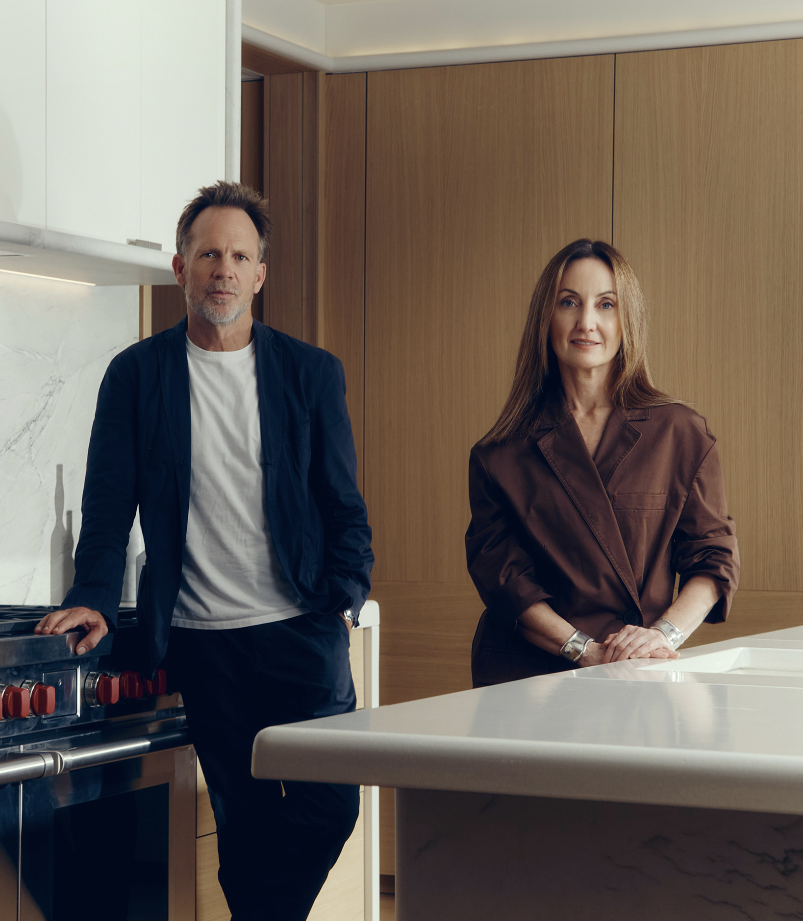Jonathan Richards and Kirsten Stanisich, the interior designers of the luxury townhouses for sale in St John's Wood Square, standing in a marble kitchen.