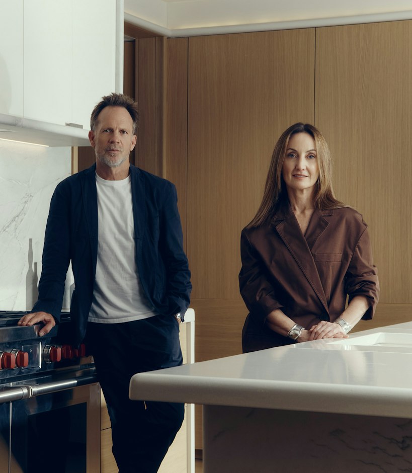 Jonathan Richards and Kirsten Stanisich, the interior designers of the luxury townhouses for sale in St John's Wood Square, standing in a marble kitchen.