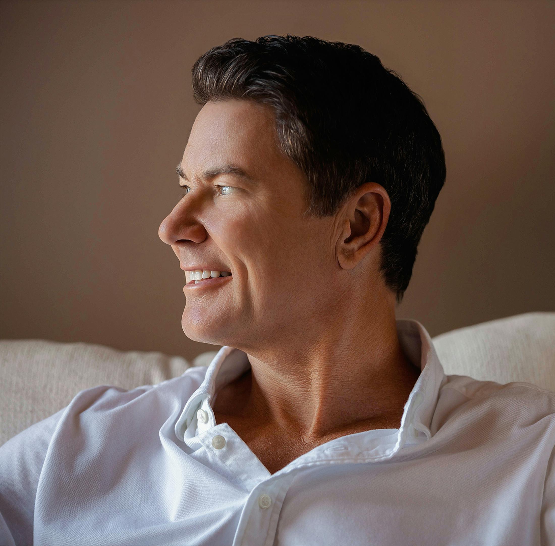 Man smiling and looking off to the side