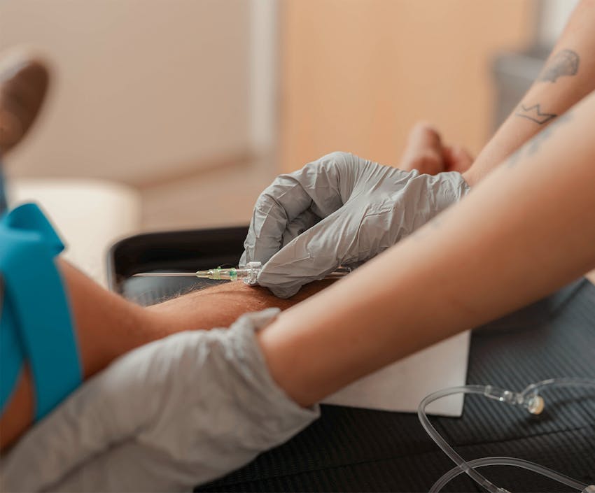 Someone about to put an iv in