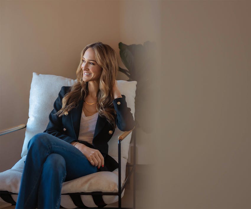 Woman smiling and touching her hair