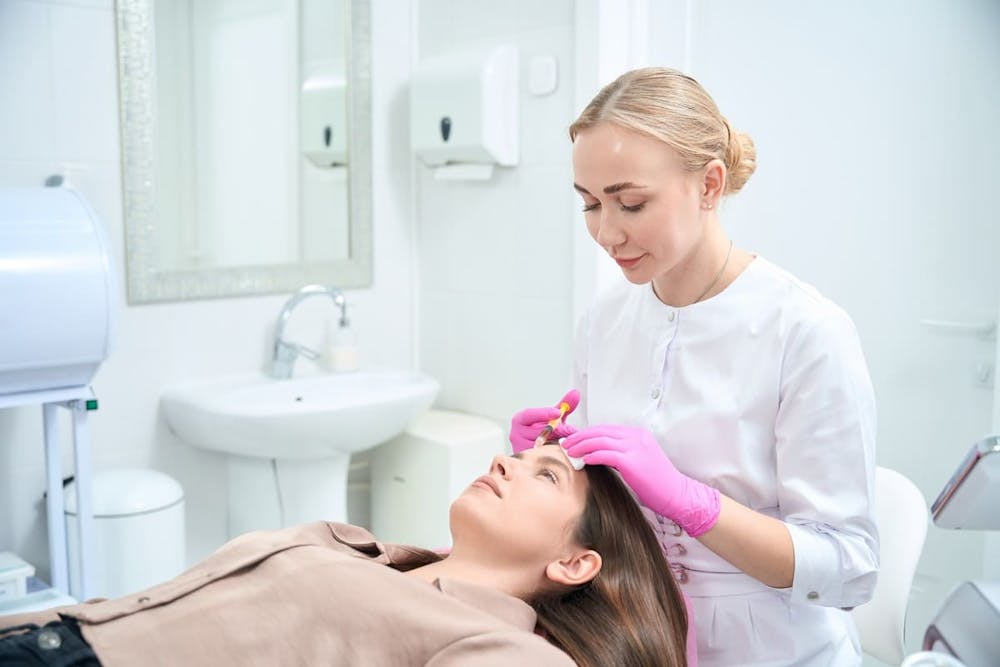 woman getting forhead treatment