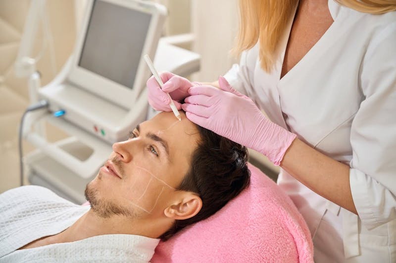 man getting treatment on forehead